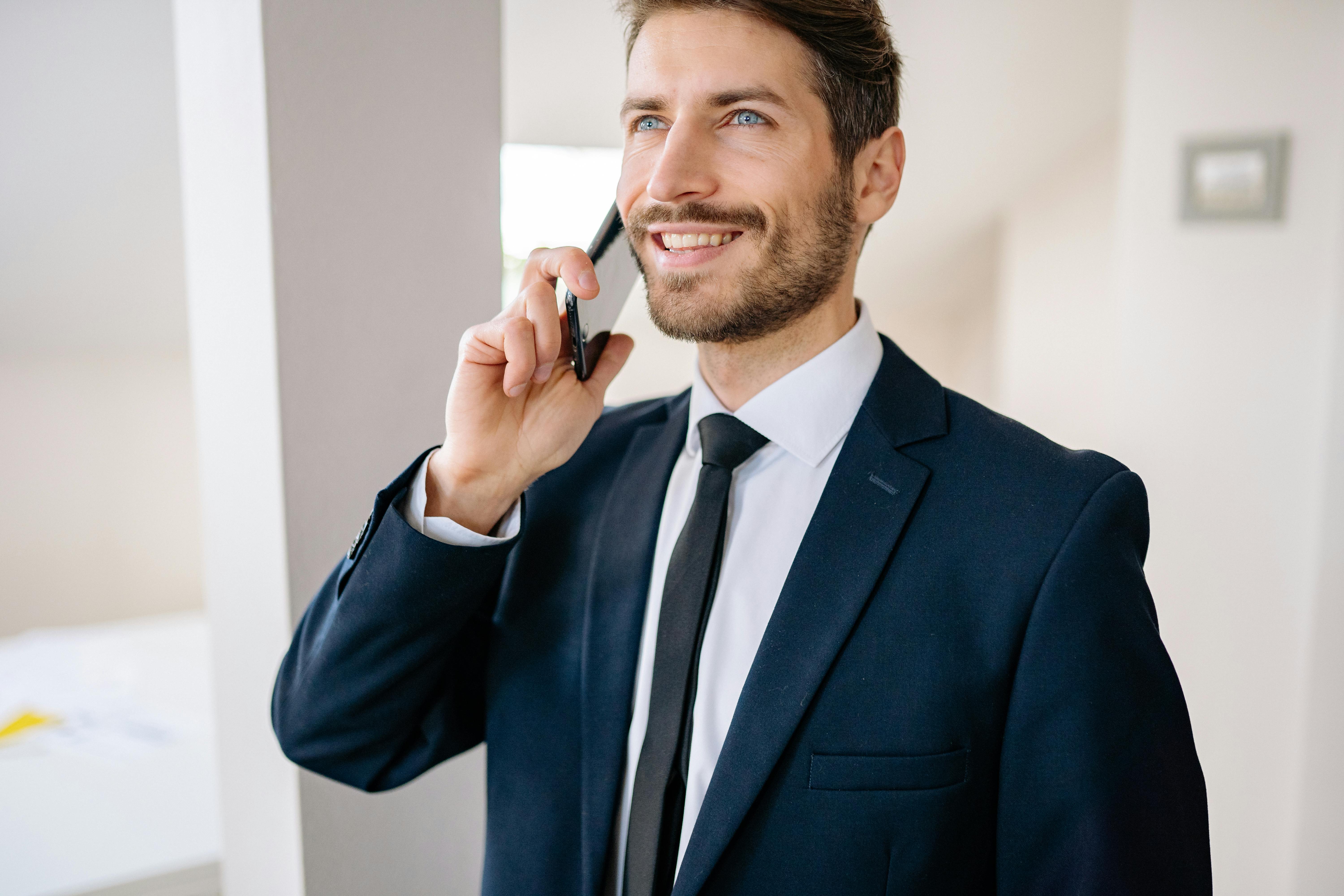 Professional businessman smiling while talking on phone
